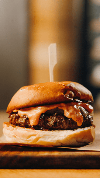 burger with cheese dripping down sides at snowmass dining
