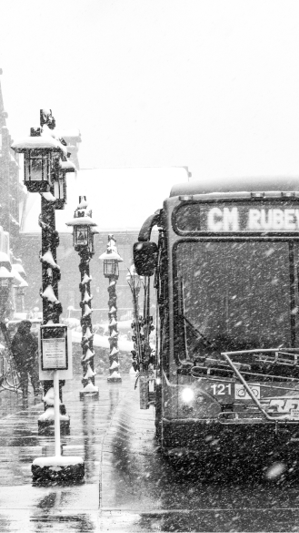 Black and white image of the bus going to aspen highlands from town on a snowy day
