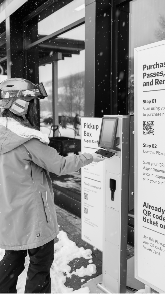 woman prints out ticket at snowmass to ski