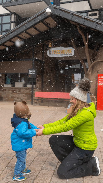 Woman reaches out to her son as she drops him off at childcare at aspen