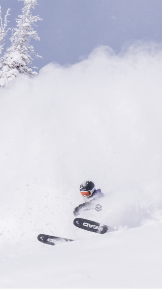 skier in deep powder at Aspen Snowmass