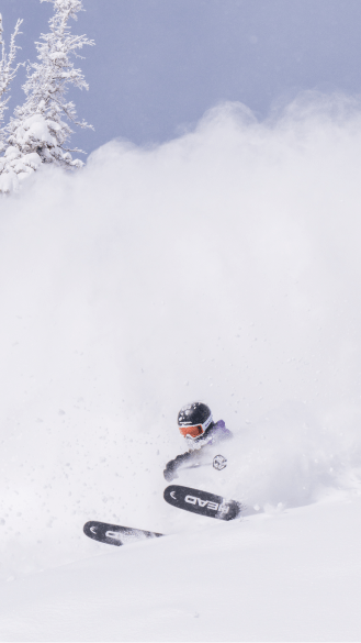 Skier in powder on blue bird day