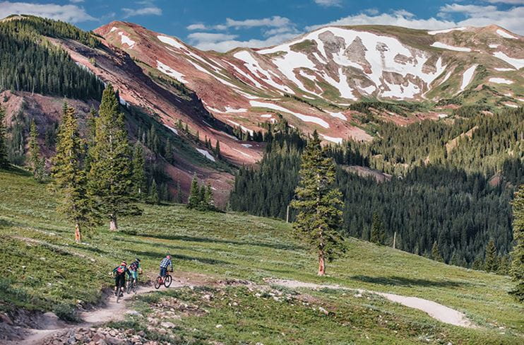 Bikers take a turn at the scenic Snowmass Bike Park
