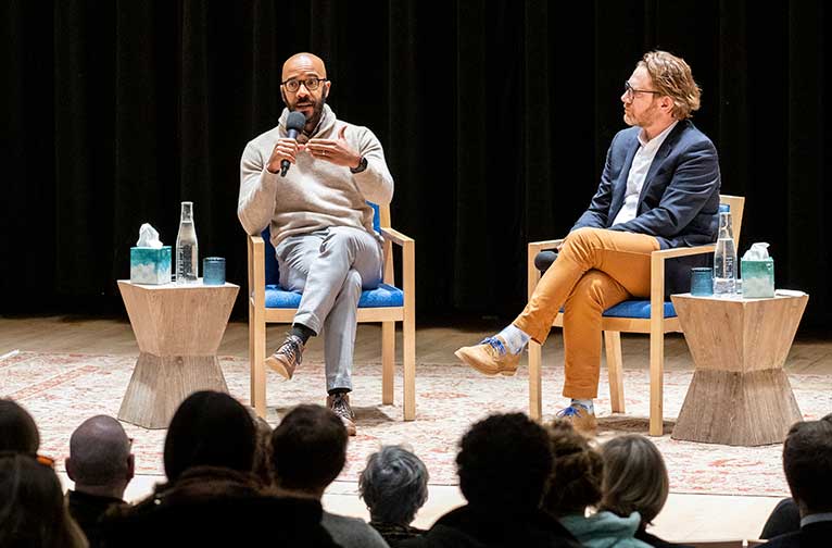 Two people talk onstage speak to an audience at Aspen Words, a summer literary event.
