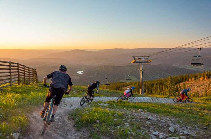 Mountain bikers turning on a trail above treeline at Snowmass