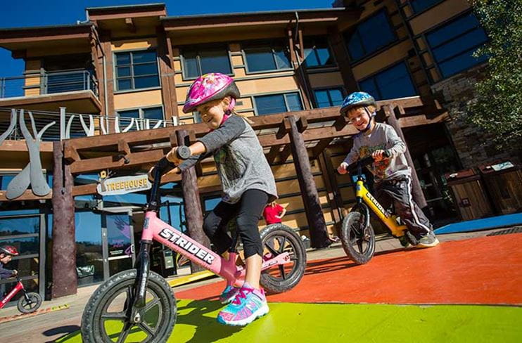 Young children riding Strider Bikes at Camp Aspen Snowmass