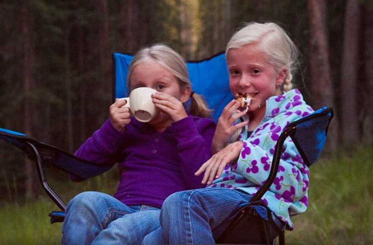 Two girls enjoy camping