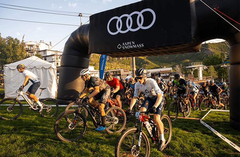 Start of the power of four bike race, racers take off under the Audi start banner, in the early morning