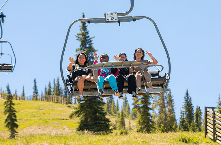 Girls ride on chairlift at Snowmass