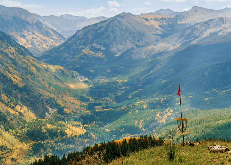 Sun shines down on the valley below, yellow and green leaves color the vast valley
