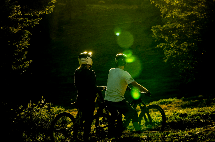 Two bikers at dawn on the downhill park