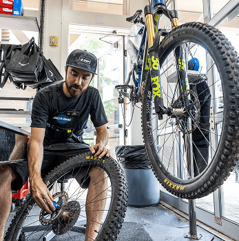 Shop employee works on bike
