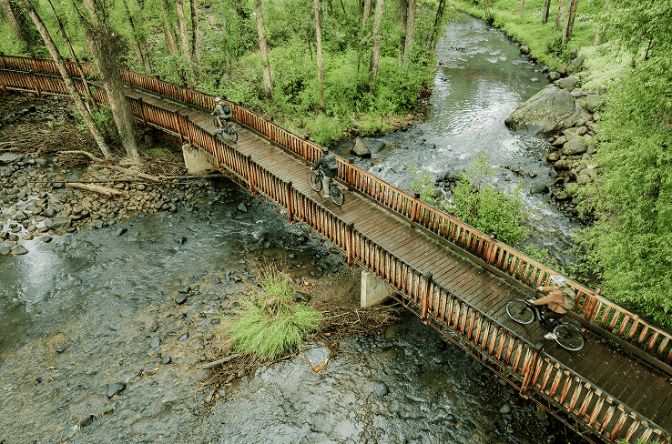Couple on bridge in Aspen on ebikes