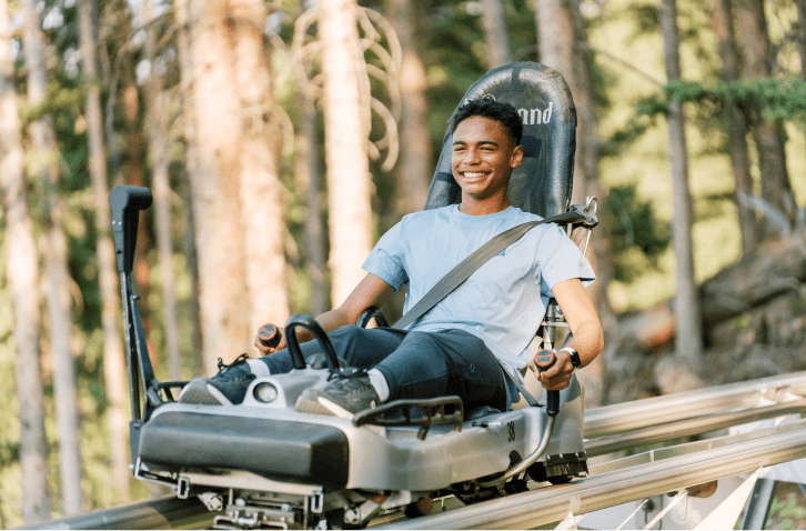 Man rides the coaster through the forest at Lost Forest, Snowmass