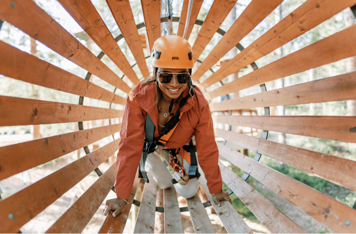 Woman crawls through wooden slates of lost forest