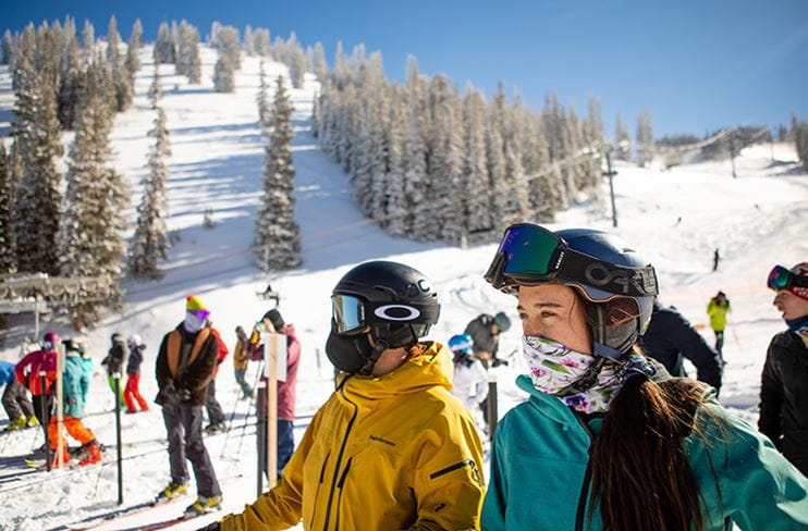 Two skiers at Aspen Mountain where mobile technology makes things easier