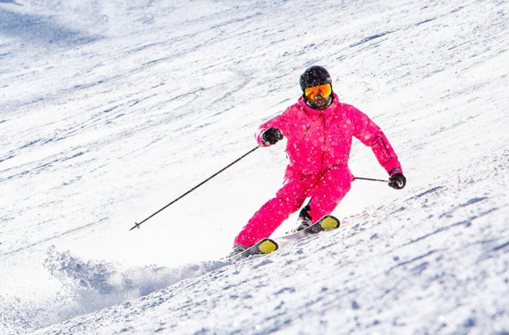 Skiing at Aspen Snowmass in a pink jump suit