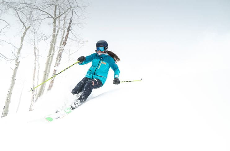 A woman skis in ideal conditions at Buttermilk