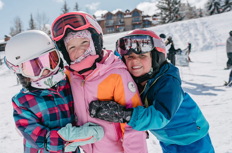 Child skiers hugging
