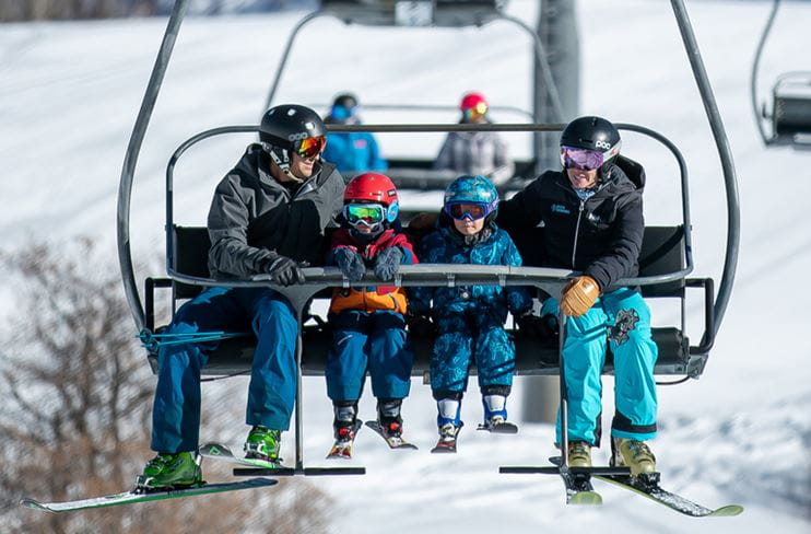 A family rides the lift at Buttermilk