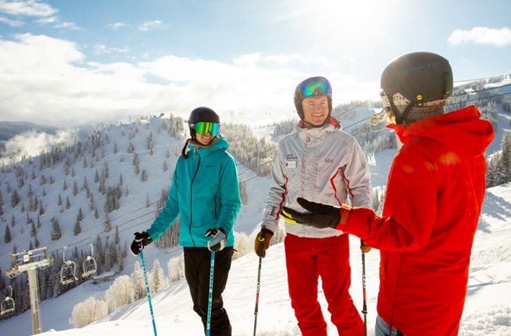 A ski instructor works with two students at Aspen Mountain