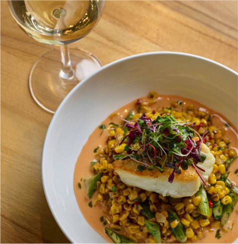 Close up of a fine dining dish and glass of wine