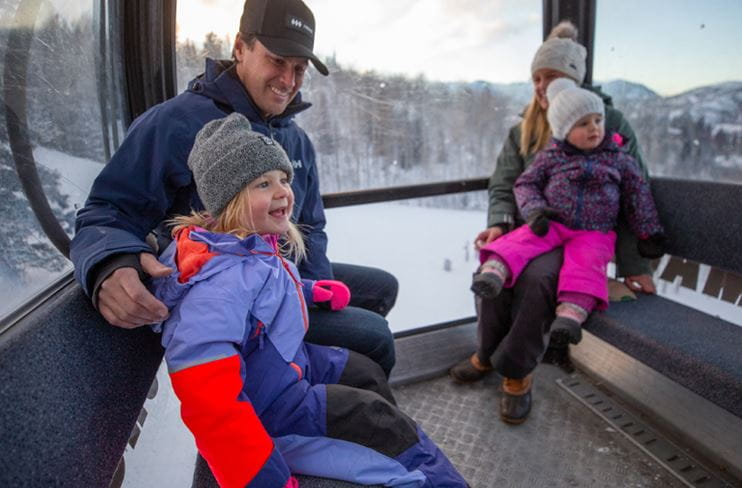 A family riding the gondola at Snowmass
