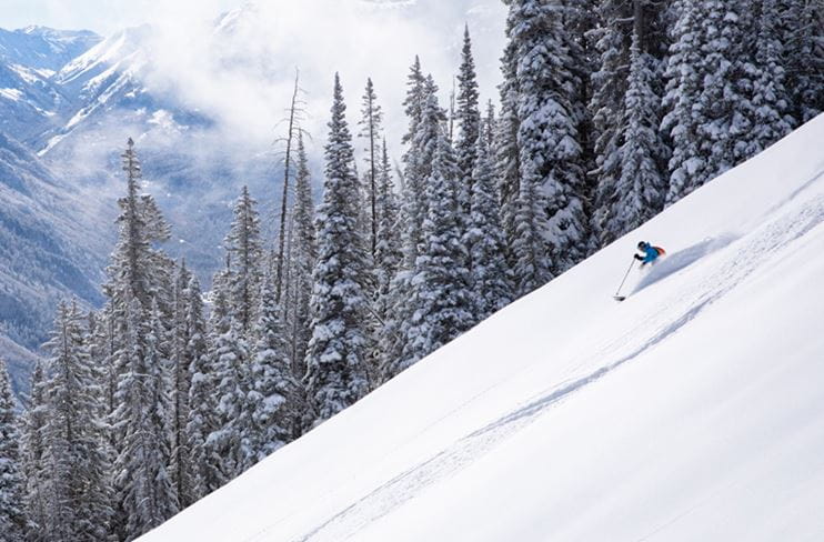 A skier explores the empty intermediate terrain on Aspen Mountain