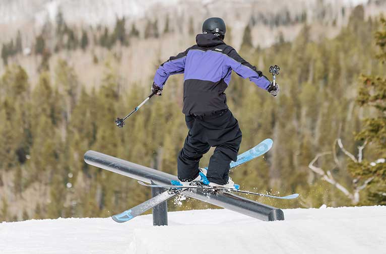 A skier riding a rail at Snowmass terrain park