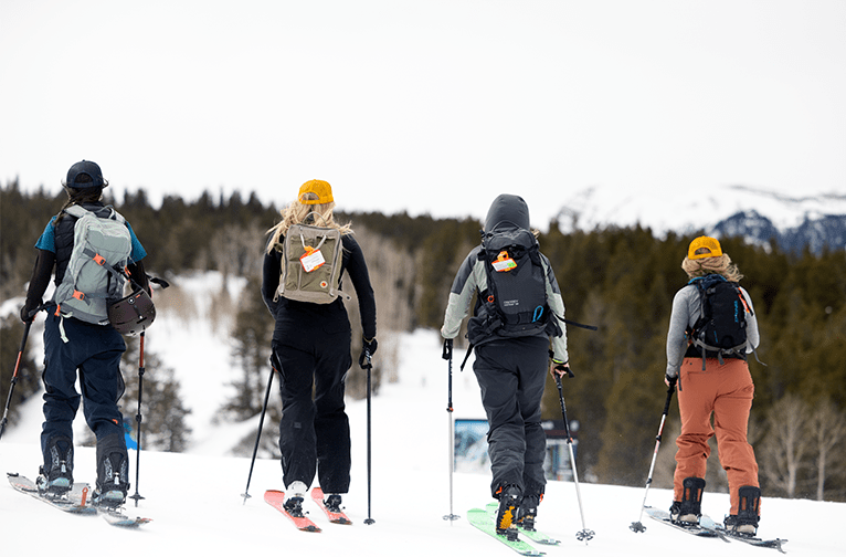 Looking at the back of 4 four women uphilling at Buttermilk, Aspen.