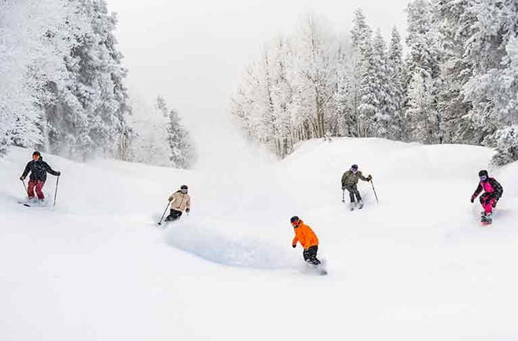 Skiers and Snowboarders in Snowmass on a Powder day. 