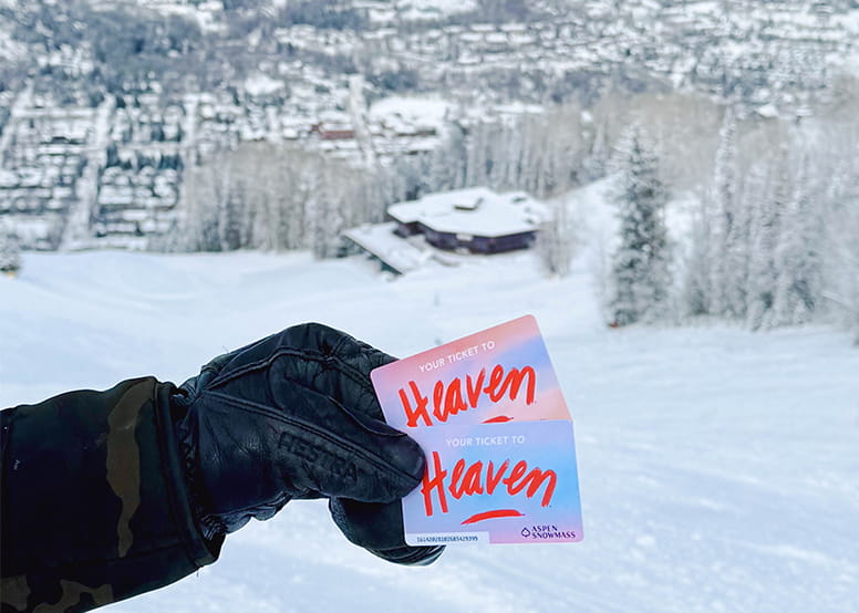 Heaven lift ticket artwork head above the Ruthies building on Aspen Snowmass