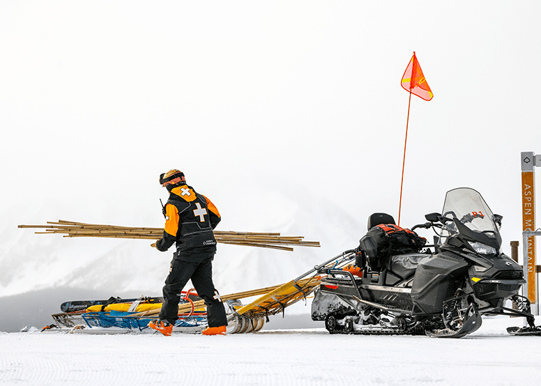 Aspen Snowmass Ski Patrol loads stakes into a snow mobile bed