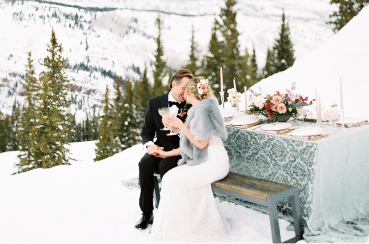 Husband and Wife kiss atop Aspen Highlands at cloud nine, on a winter wedding day