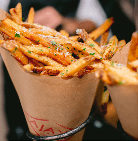 Truffel parmesan fries wrapped in paper, at Ajax Tavern