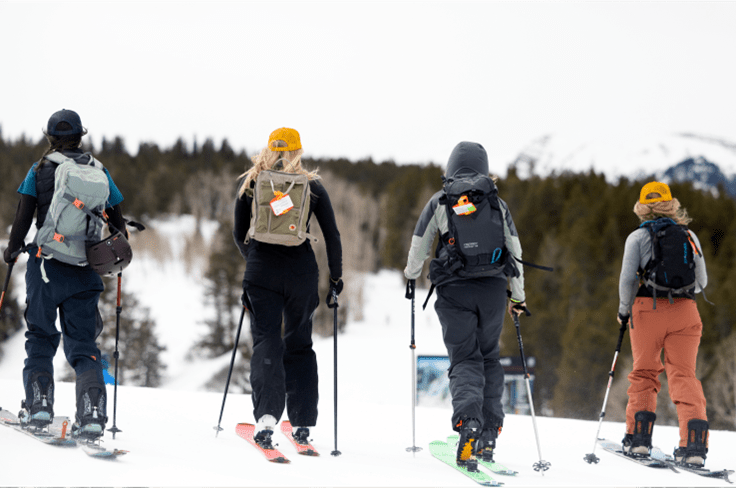 Four women uphill on a gray morning at Buttermilk for uphill breakfest