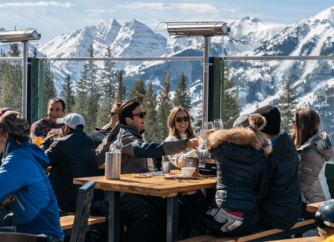 Group of people cheers their glass at Cloud Nine on a winter day on the patio
