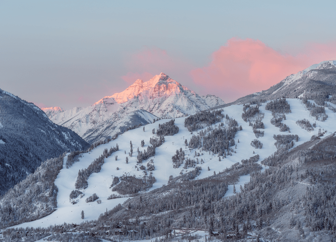pink skies over white ski runs at Buttermilk Mountain