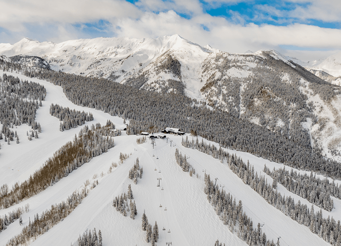 The top of sams knob at Snowmass ski resort, cloudy skies over the white runs