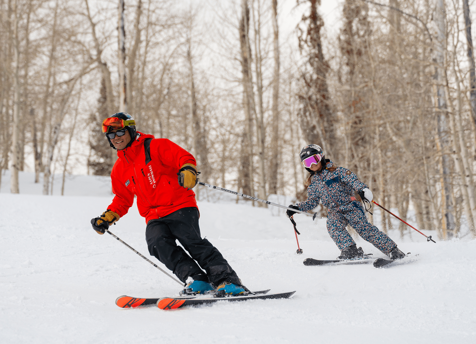 Ski Pro teaches a child to carve on the slopes of Buttermilk on a snowy day