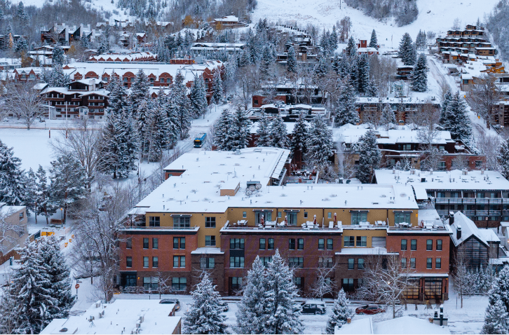 Limelight Aspen in the winter, snowy streets lined by winter trees