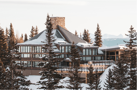 Birdseye view of High Alpine restaurant in the winter at Snowmass, sun sets over the brown roof