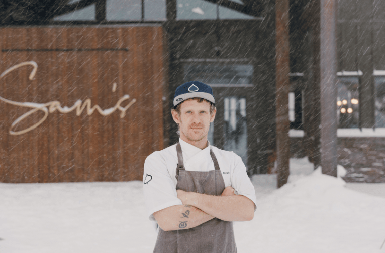 Chef standing in front of Sam's restaurant