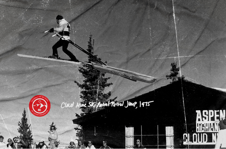 Skier over building at Aspen Mountain, black and white