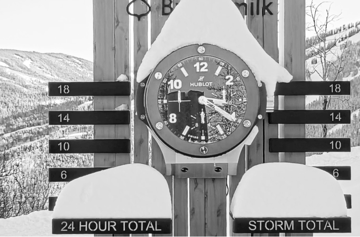black and white image of snow stake at buttermilk, with snow piled atop