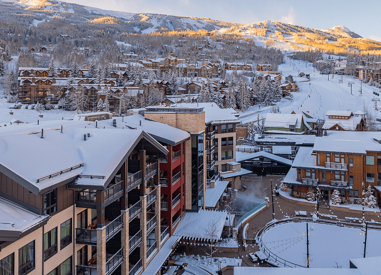 Aerial view of Limelight Snowmass, sun rising on mountain