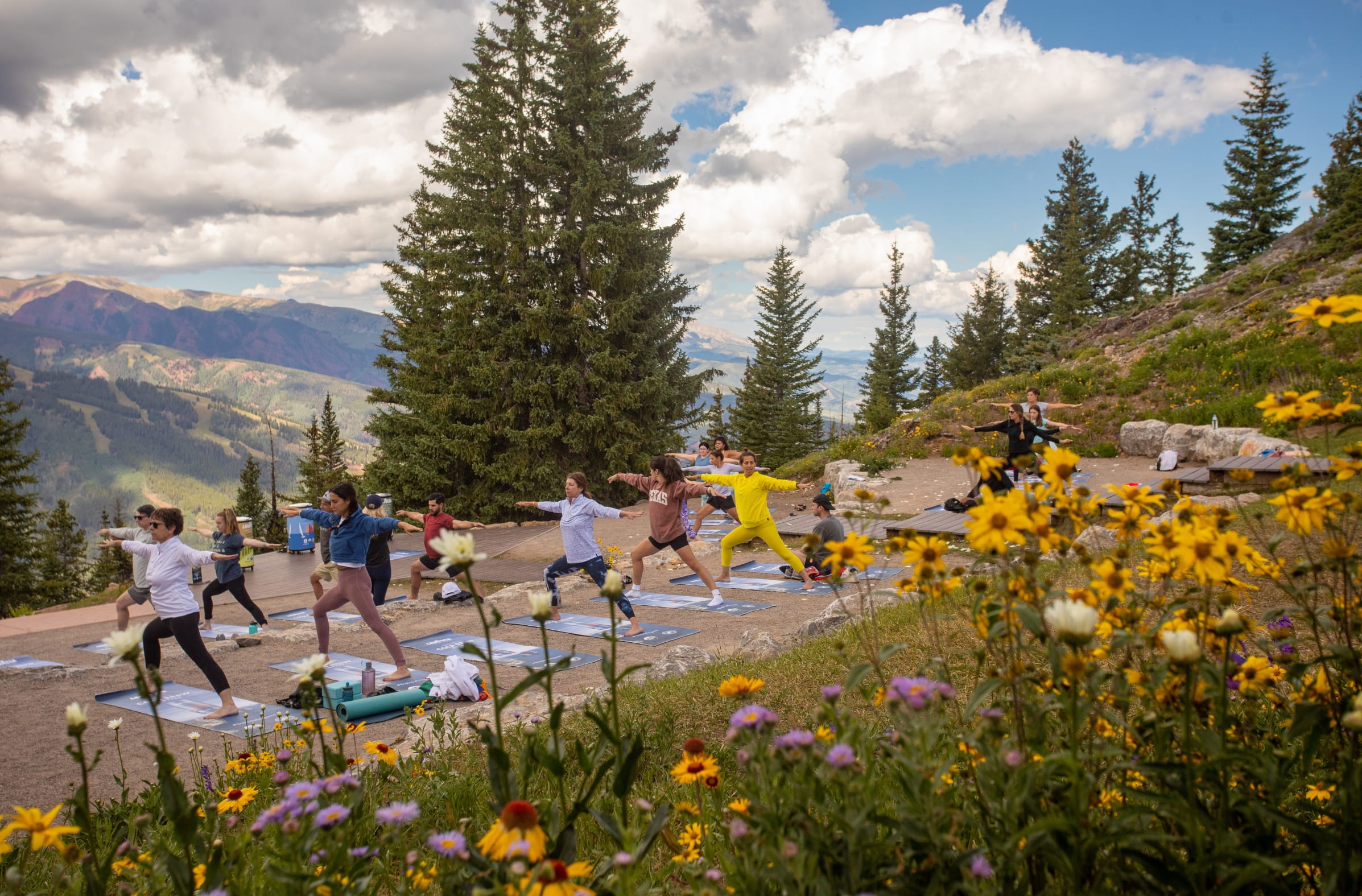 a group of people doing yoga outside
