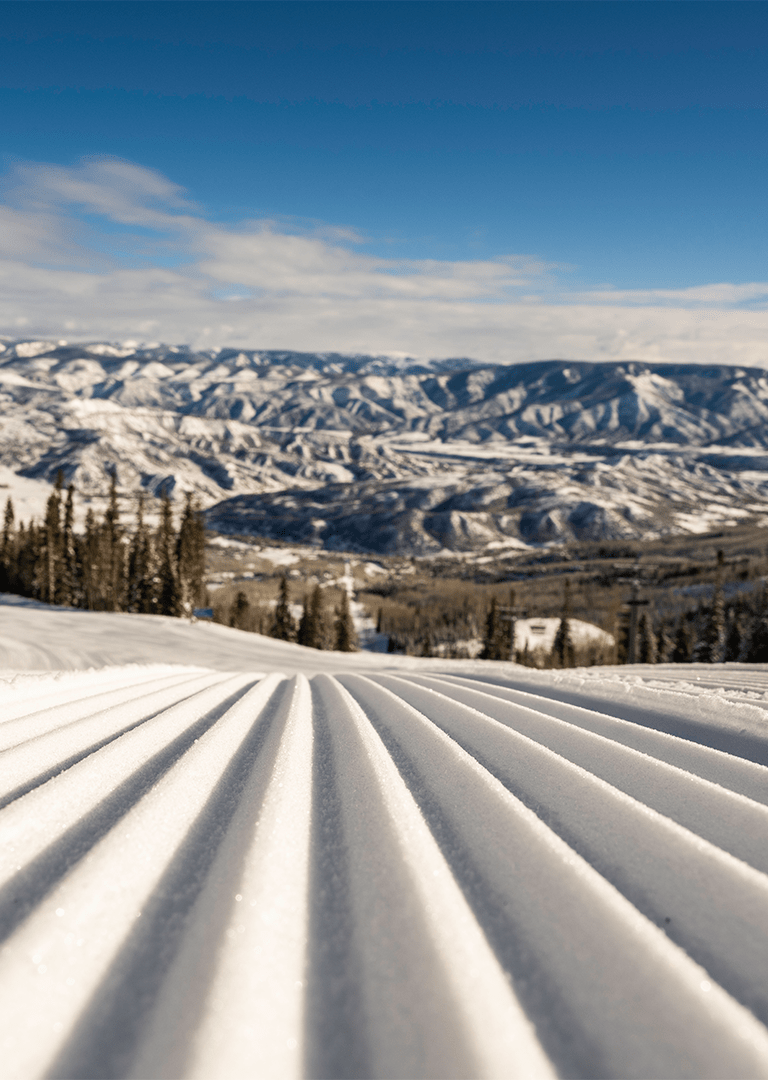close up of groomed run with Aspen Snowmass in background, a texture image
