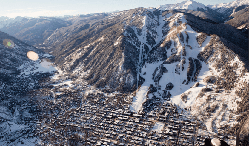 Aspen mountain from above, the town and snowy slopes visible from above