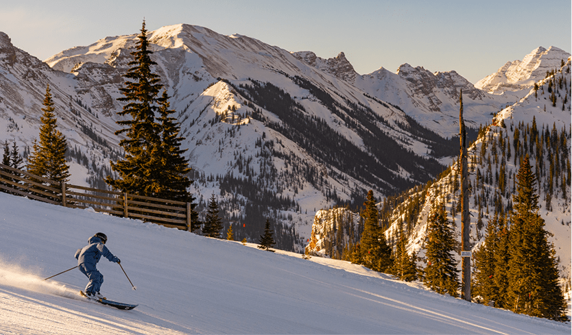 Skier on empty ski run in the afternoon at snowmass